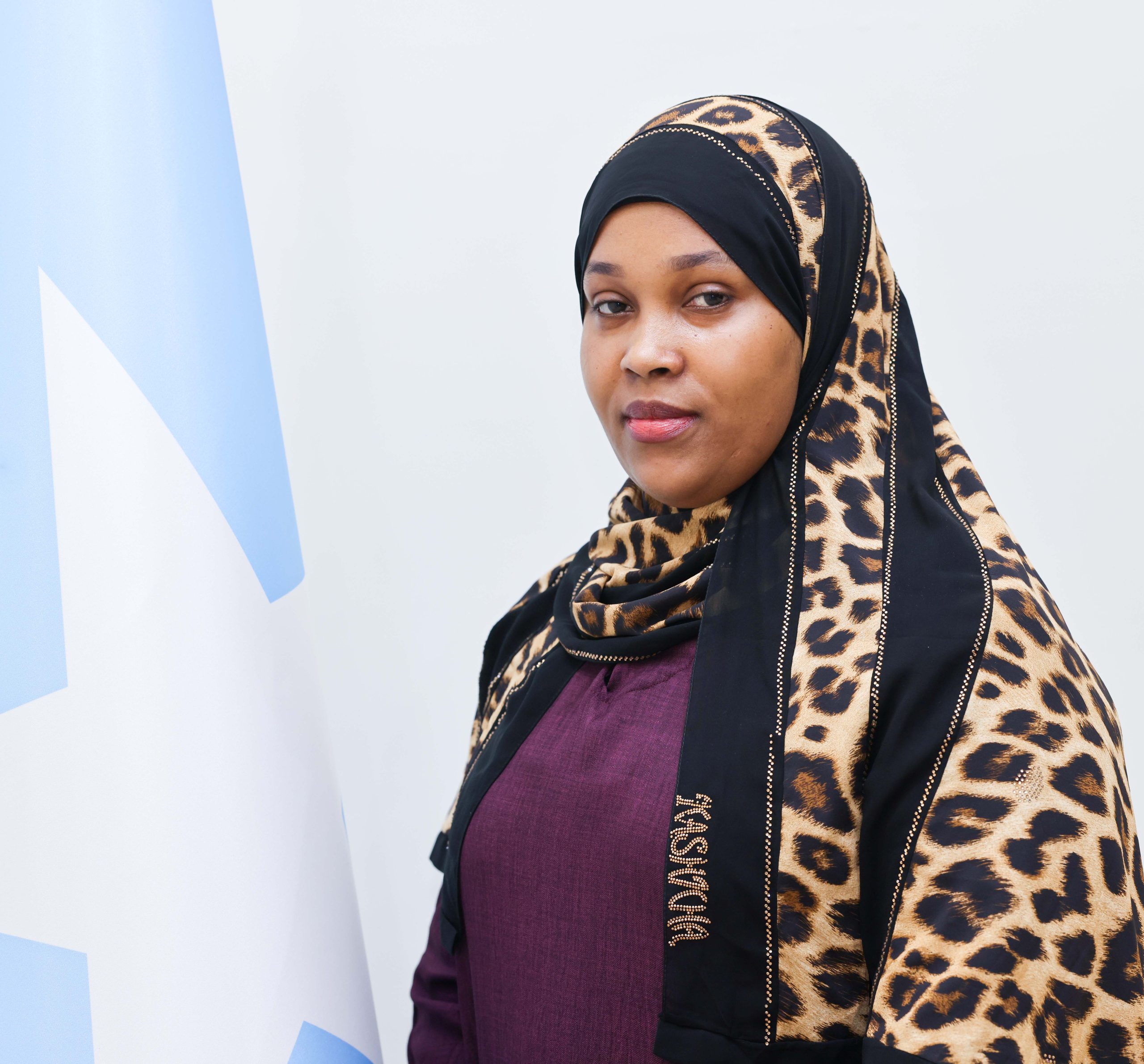 Woman wearing gray hijab in meeting room